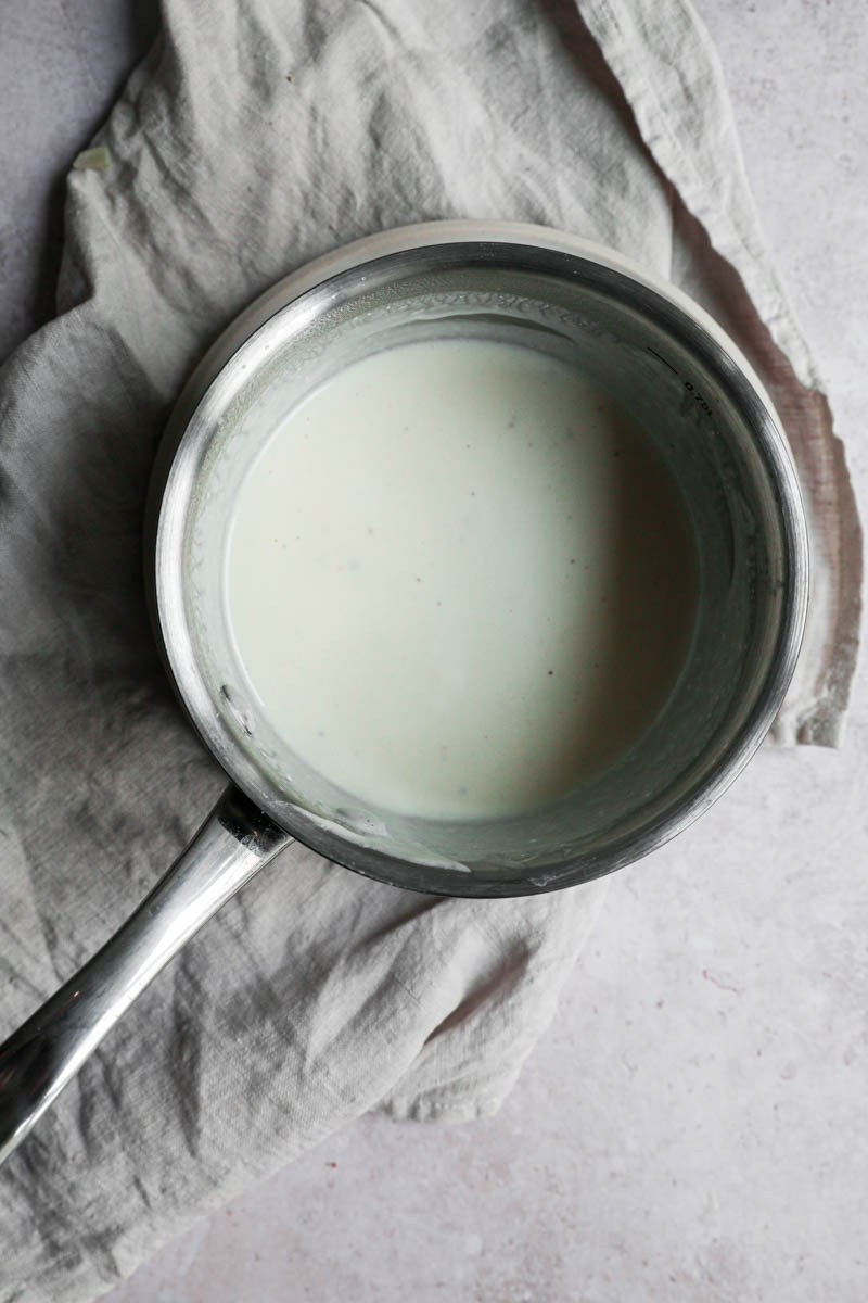 The parmesan cream sauce ready inside a small pan.