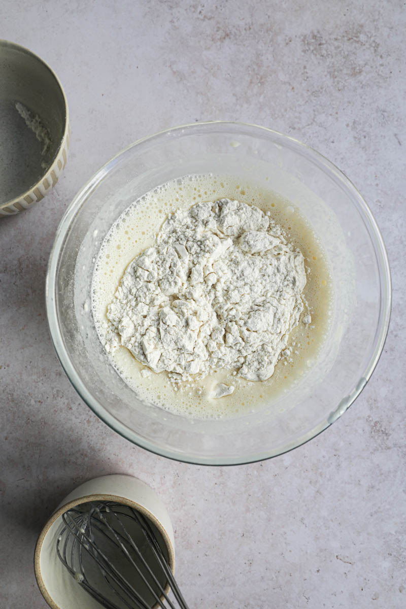 A bowl with the milk, eggs and flour, making crepe batter.