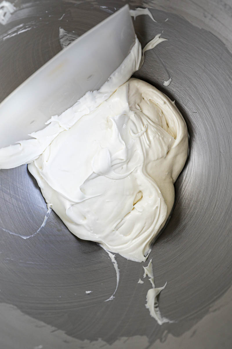 Assembly the homemade Oreo Cookies: The whipped white chocolate ganache filling inside a bowl.