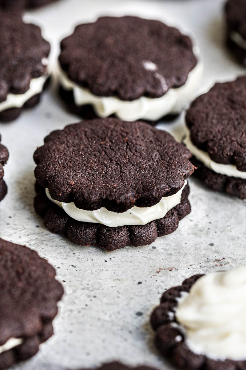 Closeup of homemade Oreo cookies arranged in lines.