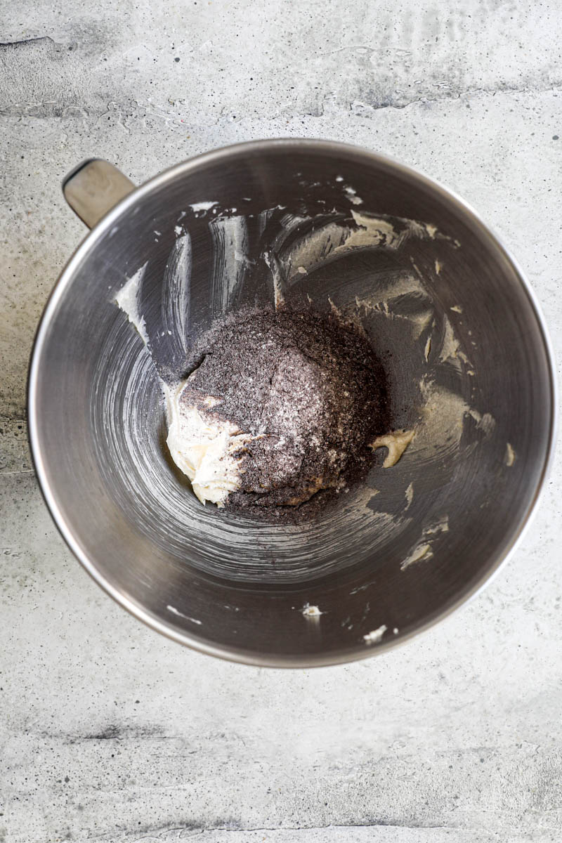 Making the homemade Oreo cookie dough: the creamed butter and sugar plus ½ of the dry ingredients in the bowl of a stand mixer.