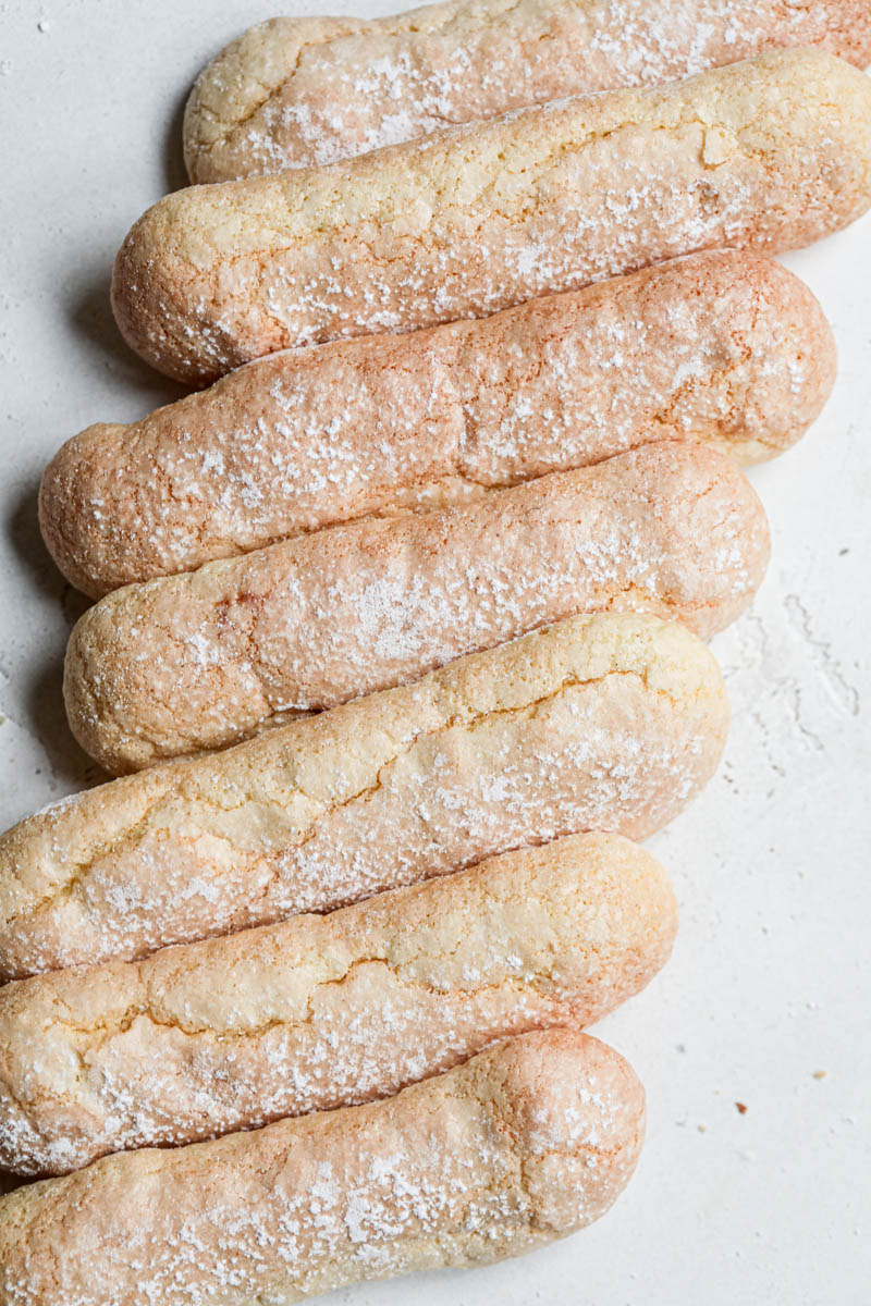 The ladyfingers cookies as seen from above arranged in an irregular manner.