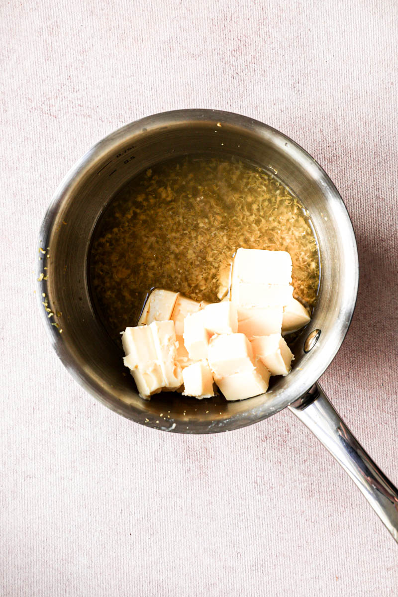 Making the lemon cream for the square lemon bars: a small pan with lemon juice, lemon zest and butter.