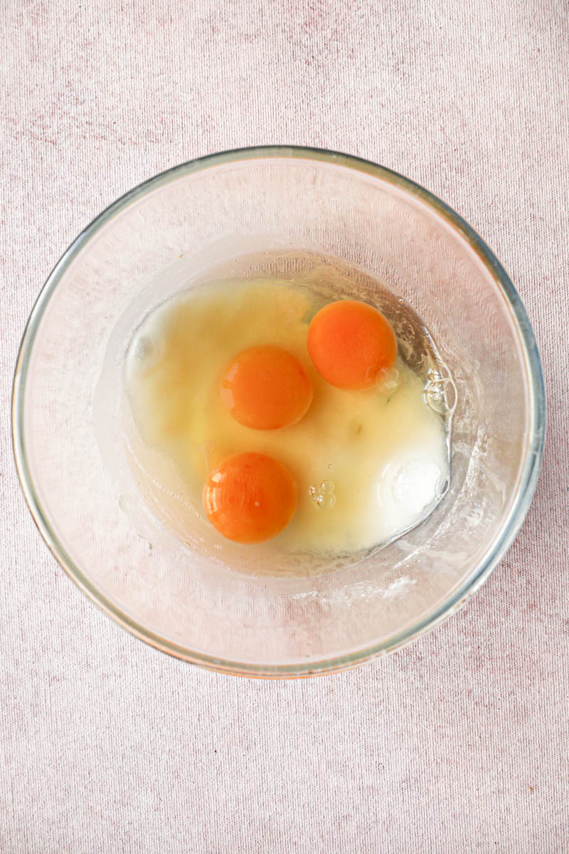 Making the lemon cream for the square lemon bars: a bowl with the eggs and the sugar.