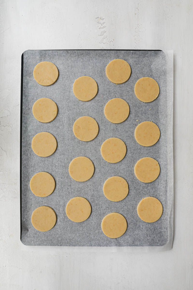 The lemon cookies placed on a baking tray lined with parchment paper.