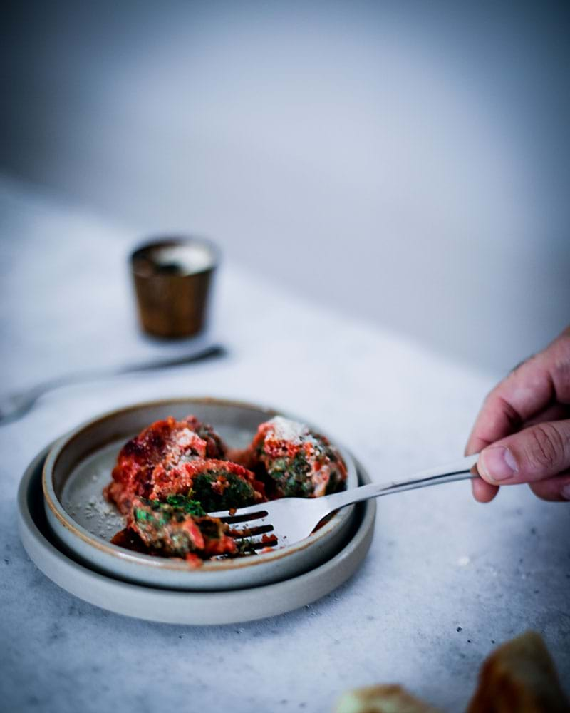 45° shot of a fork digging into the spinach malfatti