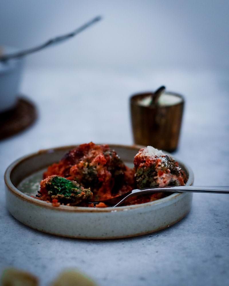 90° shot of spinach malfatti with tomato sauce