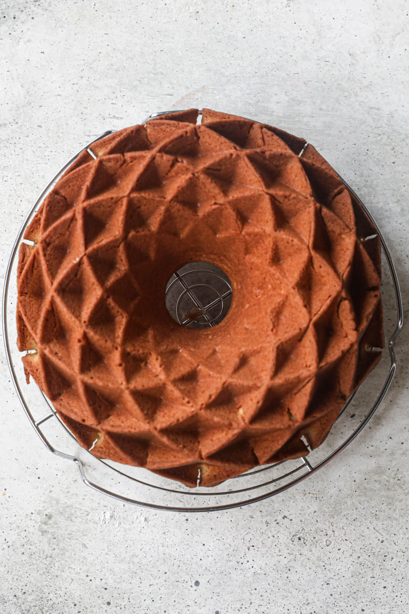 The baked mandarin orange Bundt cake on a wire rack.