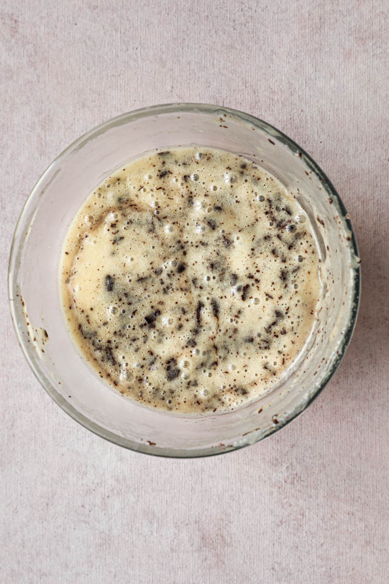 One glass bowl with the mini chocolate chip financier batter ready.