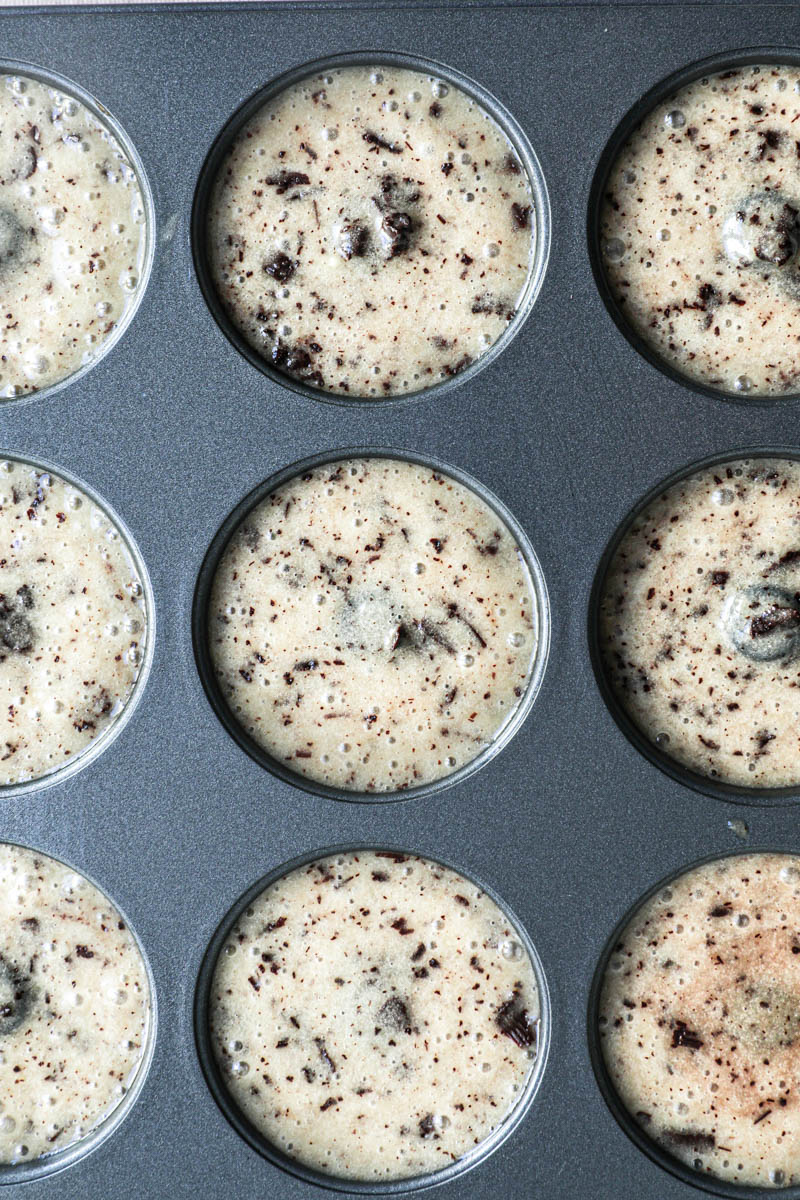 The mini donut pan filled with the mini chocolate chip financier batter.