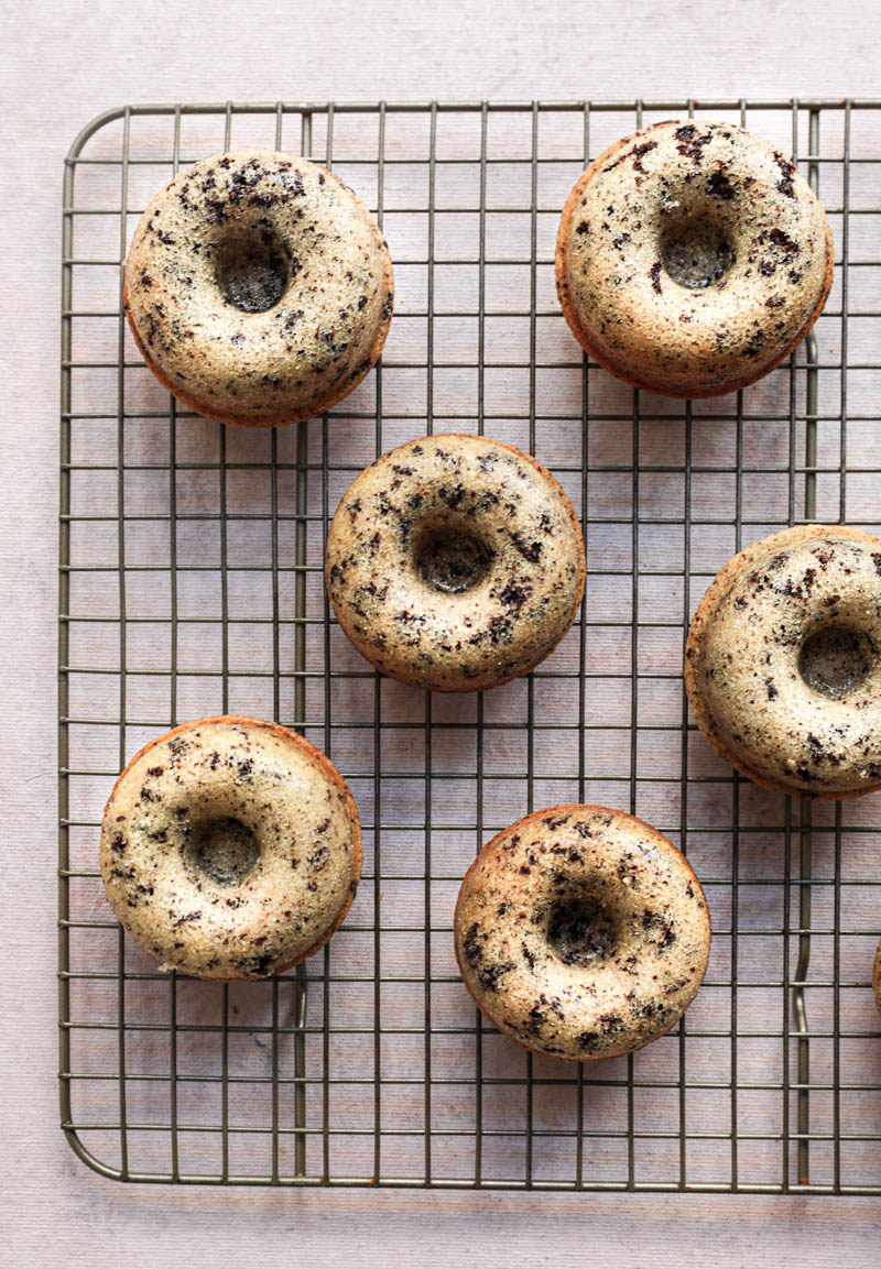 The mini chocolate chip financier almond cakes cooling off on a wire rack.