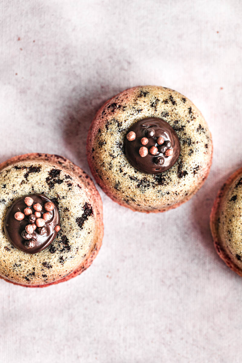 3 mini chocolate chip financier almond cakes filled with chocolate ganache as seen from above.