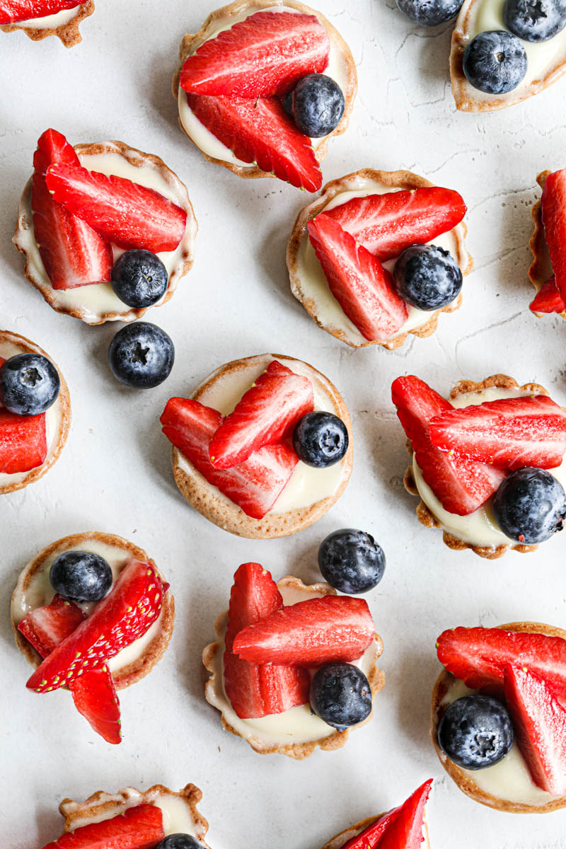 The mini strawberry lemon tartlets arranged in a random manner as seen from above.