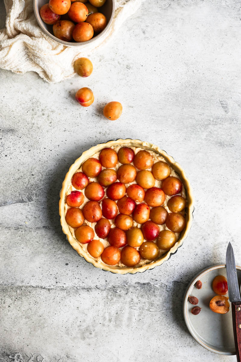 Overhead shot of the Mirabelle plum tart ready for the oven