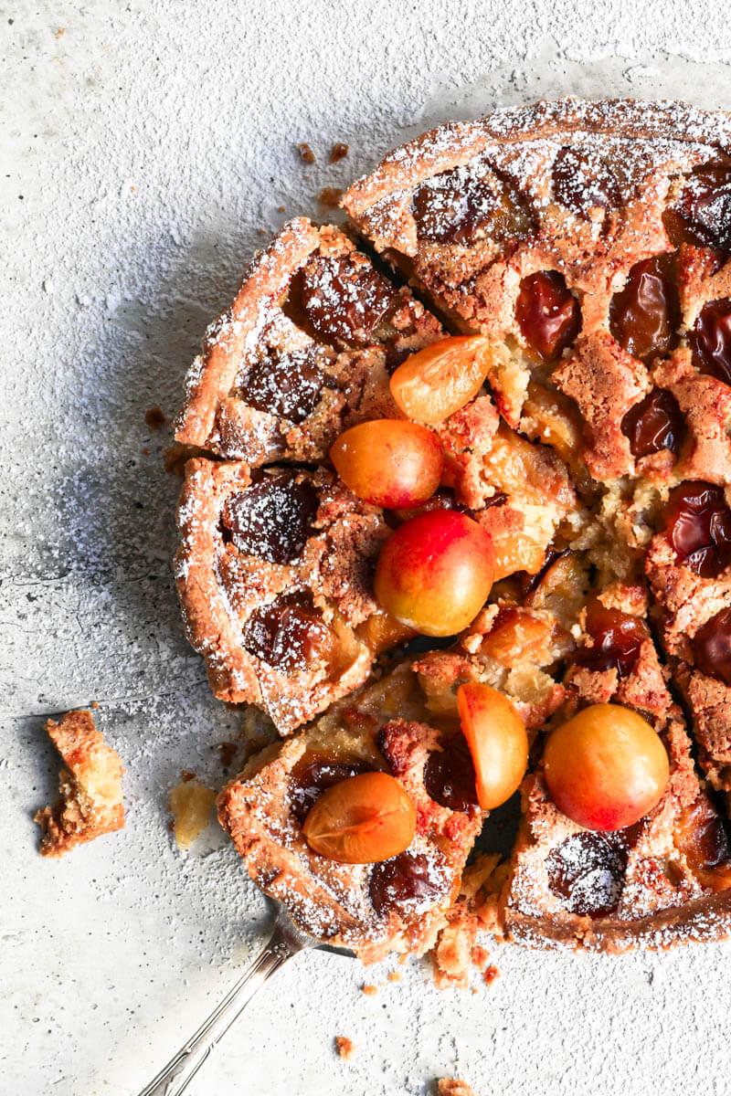 Overhead closeup shot of the sliced Mirabelle plum tart