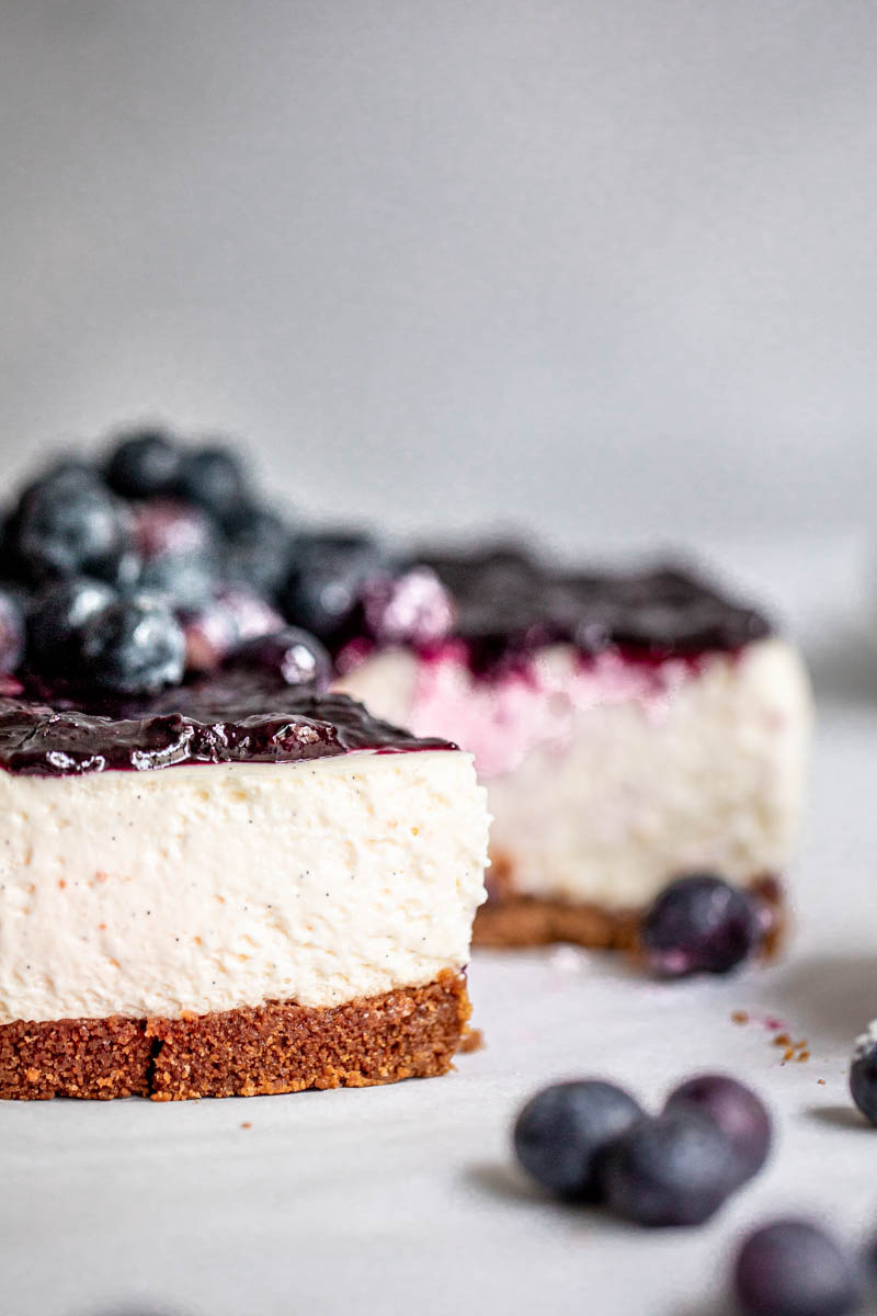 The sliced fluffy no bake vanilla blueberry cheesecake as seen from the side.