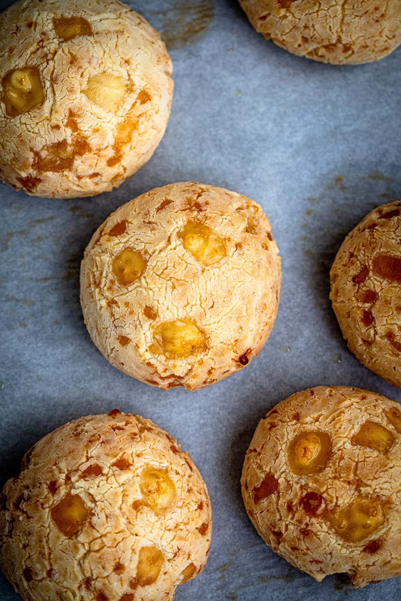 Overhead shot of pao de queijo on the baking tray with parchment paper