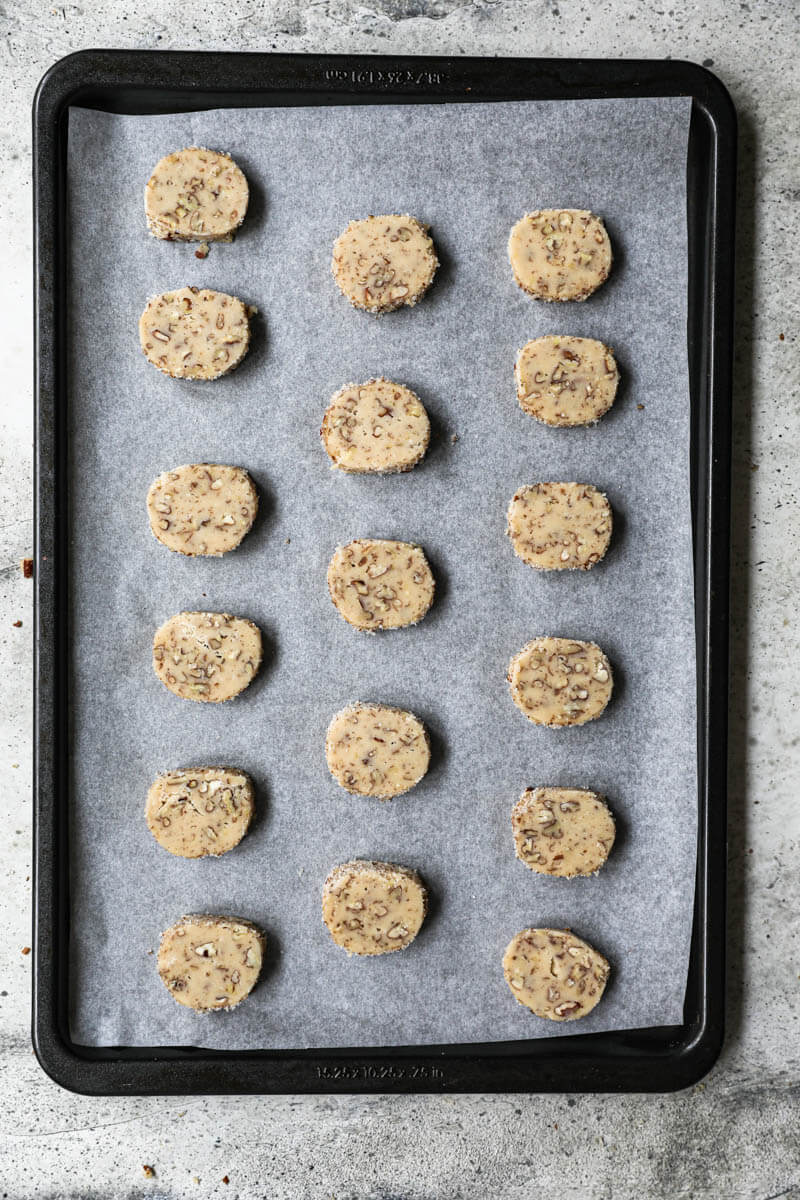 Cookies arranged on a baking tray lined with parchment paper