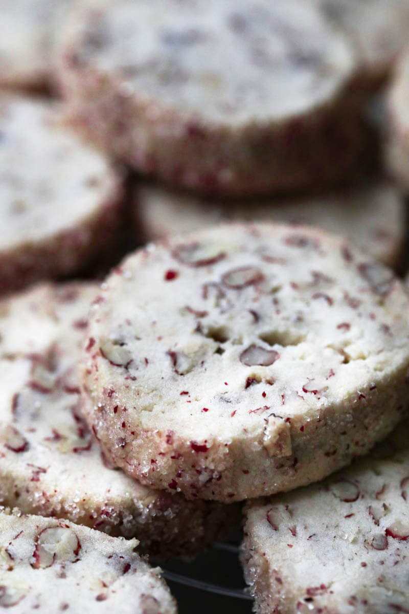 Closeup of a pecan shortbread cookie with the rest blurry