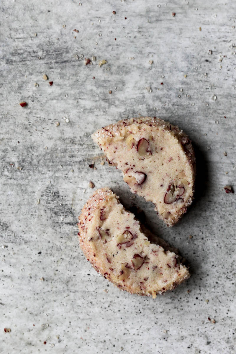 One pecan shortbread cookie broken in half