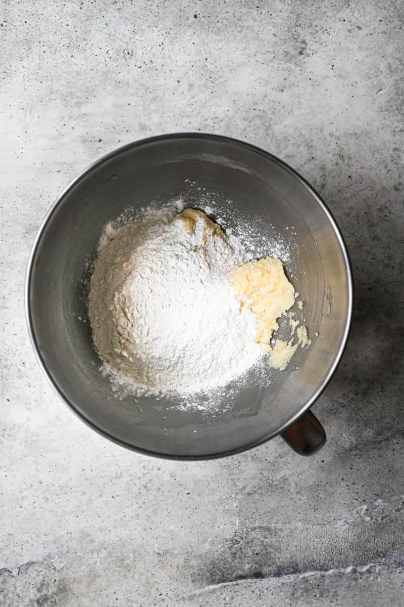 A bowl with the added flour to the dough