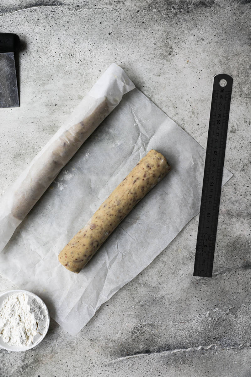 The cookie dough logs wrapped in parchment paper