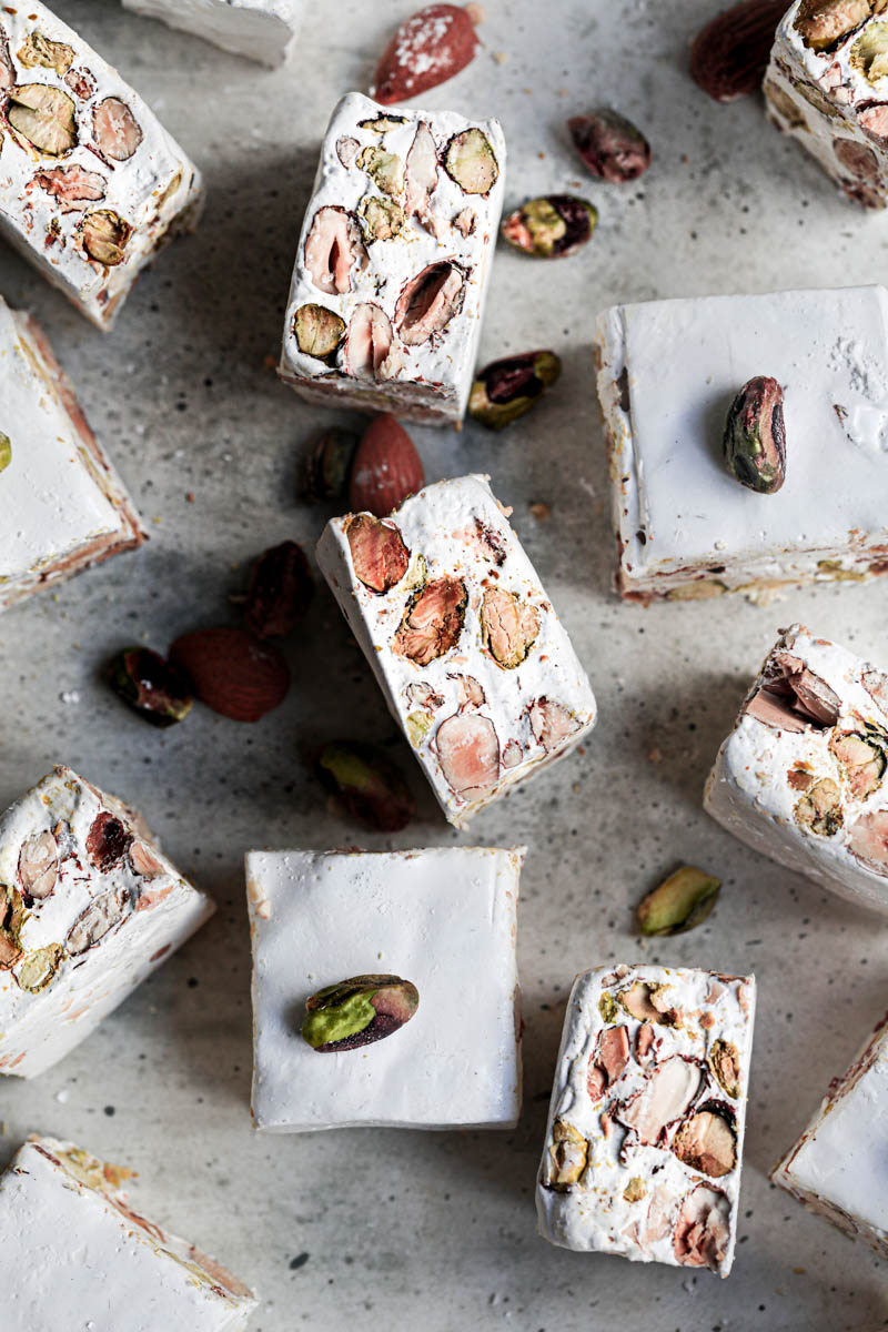The square almond pistachio nougat bars as seen from above arranged in an irregular manner.