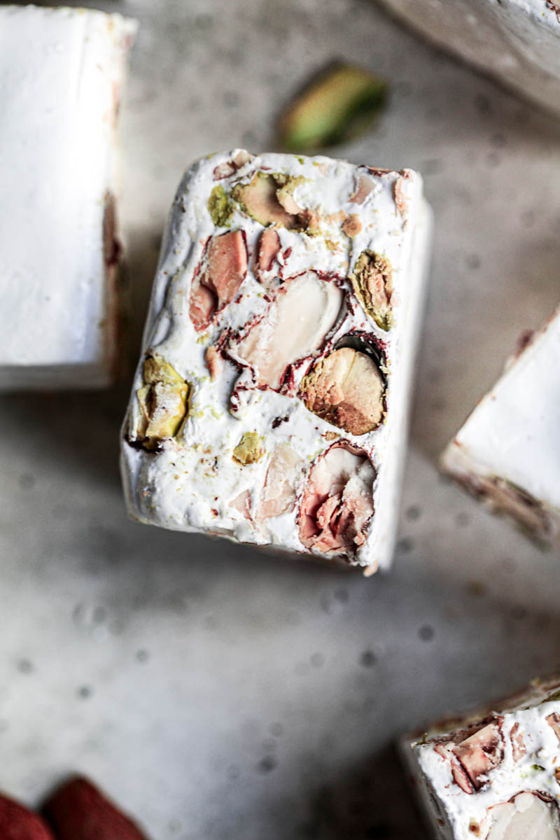 Closeup of one almond pistachio square bar as seen from above.