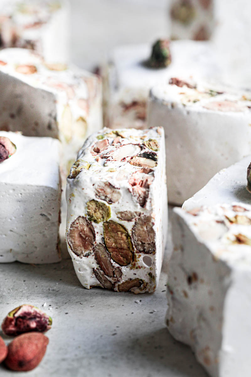 The almond and pistachio nougat squares seen from the side.