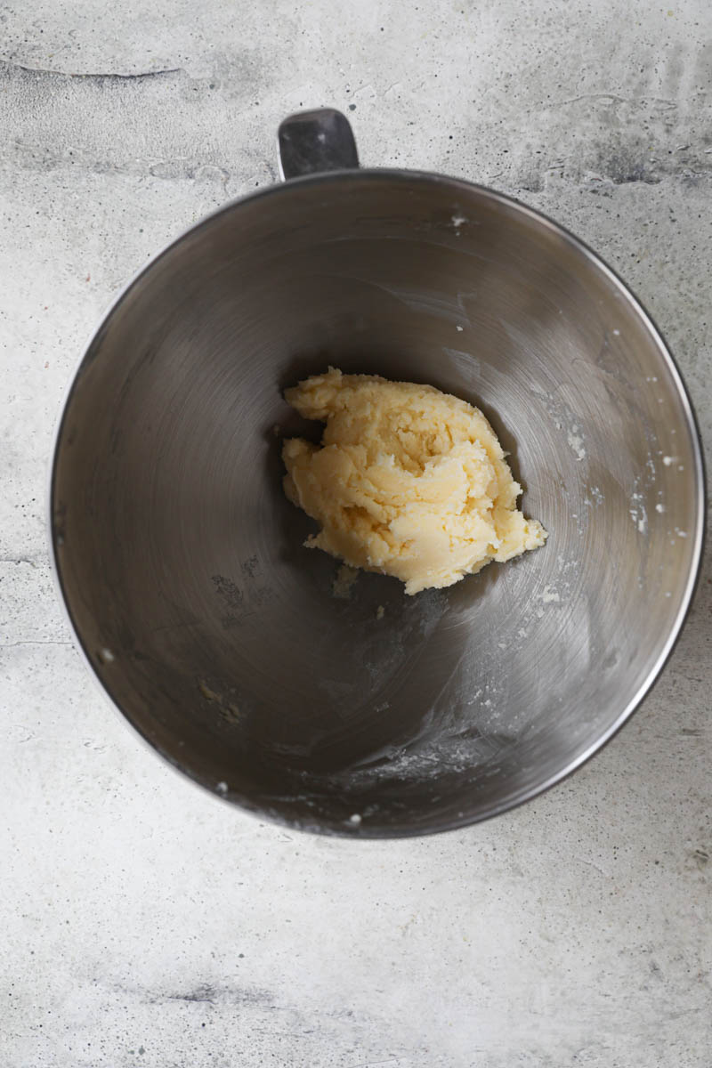 A bowl with the mixed sugar and butter to make the cranberry shortbread cookies.