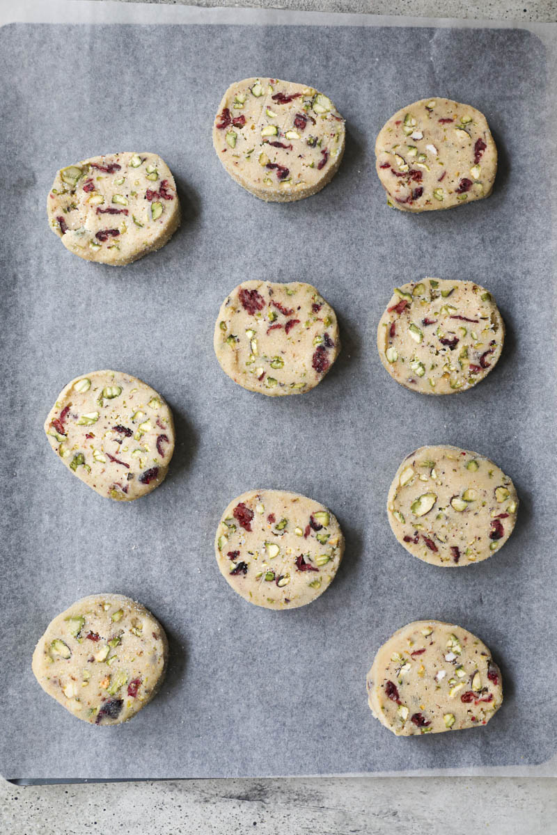 The cranberry pistachio shortbread cookies placed on a baking tray lined with parchment paper.