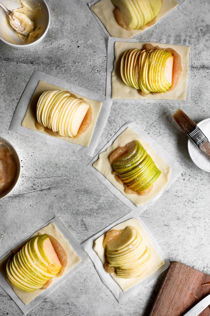 Overhead shot of all the apple puff pastry tarts ready for the oven