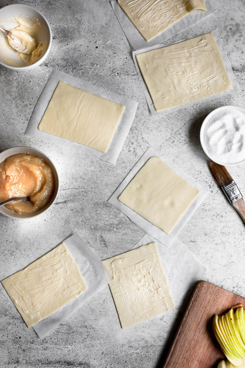 Overhead shot of the puff pastry rectangles brushed with softened butter