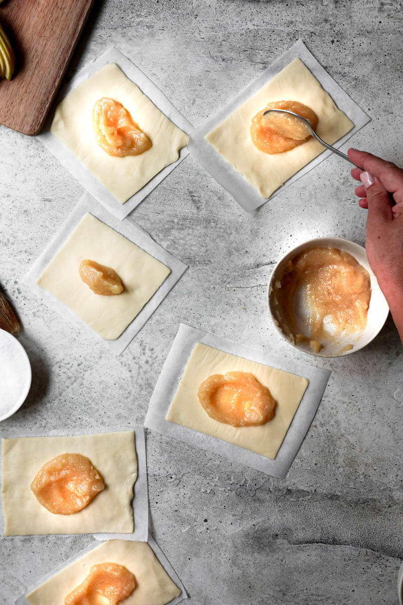 Overhead shot of all the puff pastry rectangles filled with apple compote