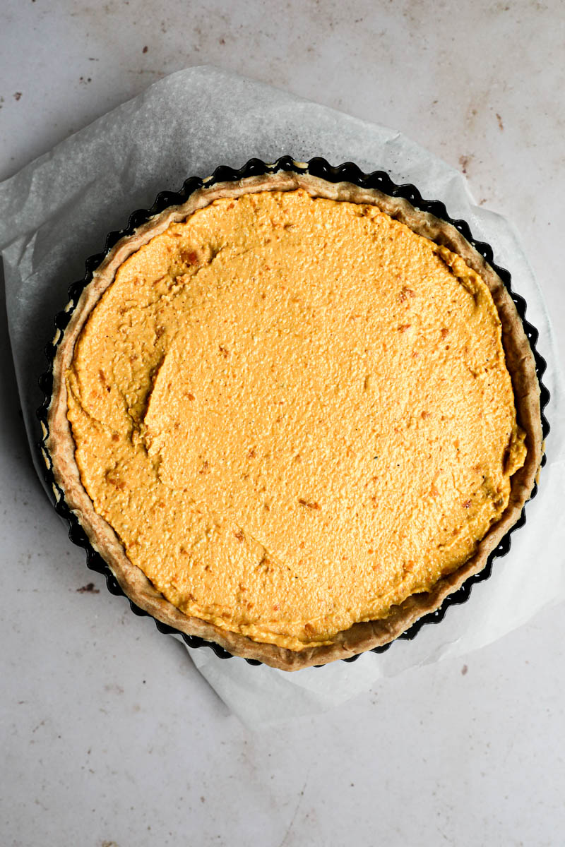 Baking the pumpkin quiche: The prebaked quiche crust filled with the fresh pumpkin filling.