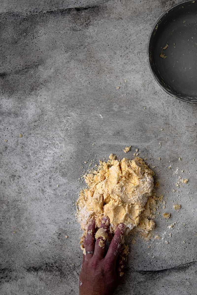 Smearing the dough using the palm of the hand until dough comes together