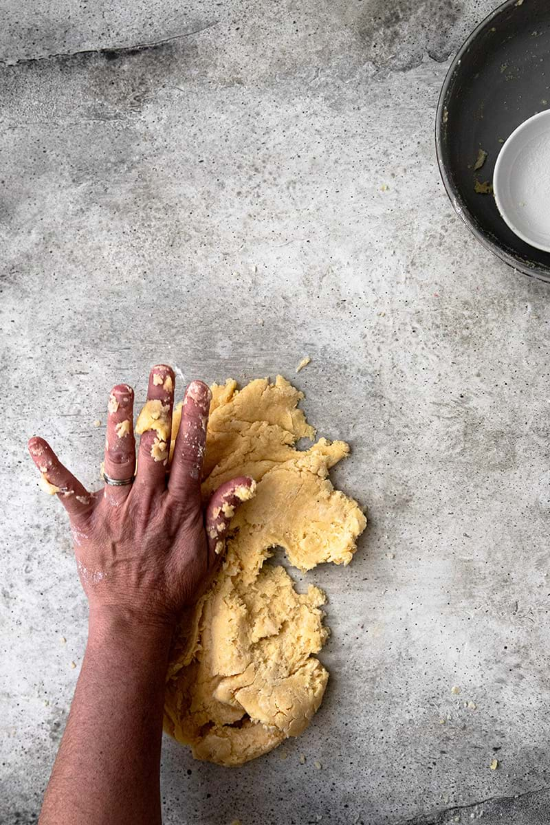 Smearing the dough using the palm of the hand until dough comes together