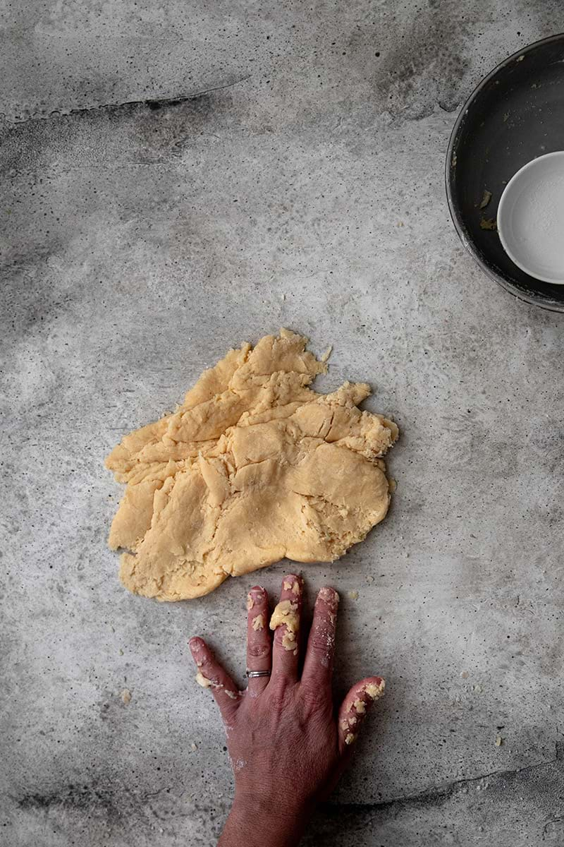 Smearing the dough using the palm of the hand until dough comes together