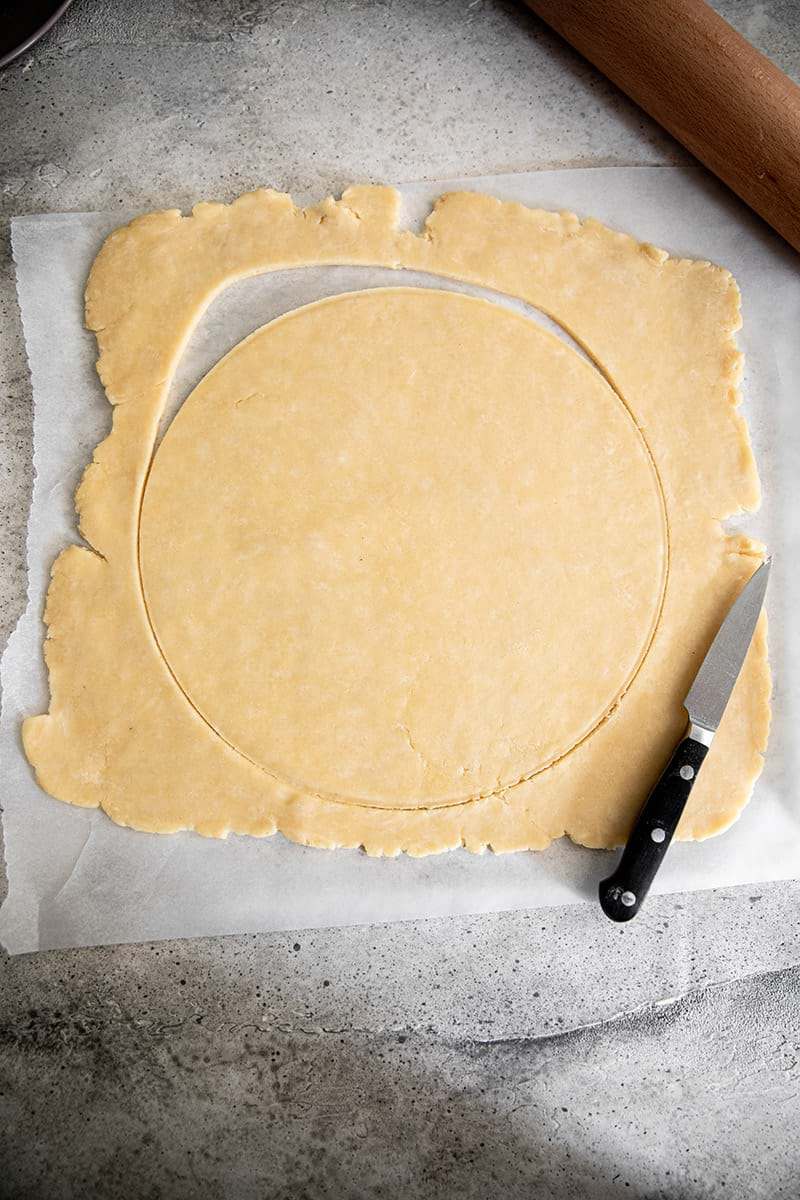 Cut out round of quiche crust dough