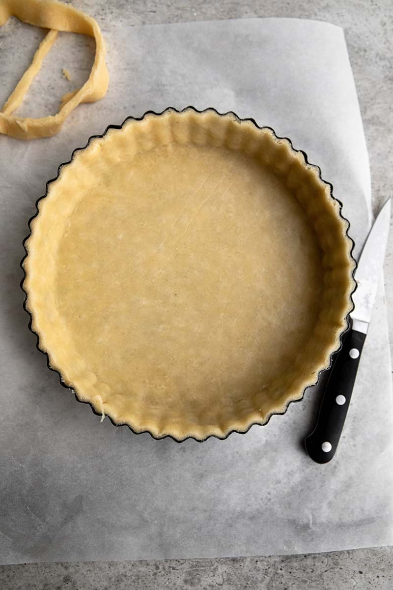 Tart tin lined with quiche crust