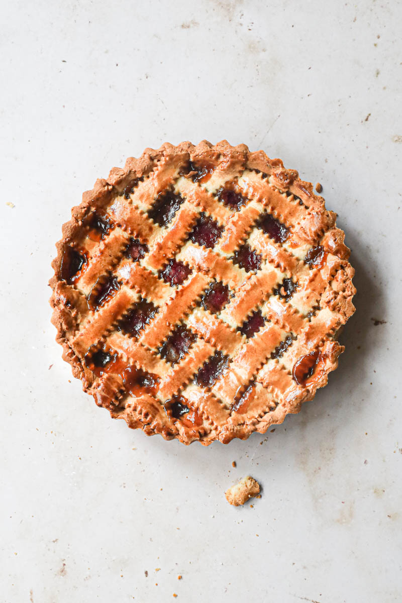 Overhead shot of the quince pie over a light surface.