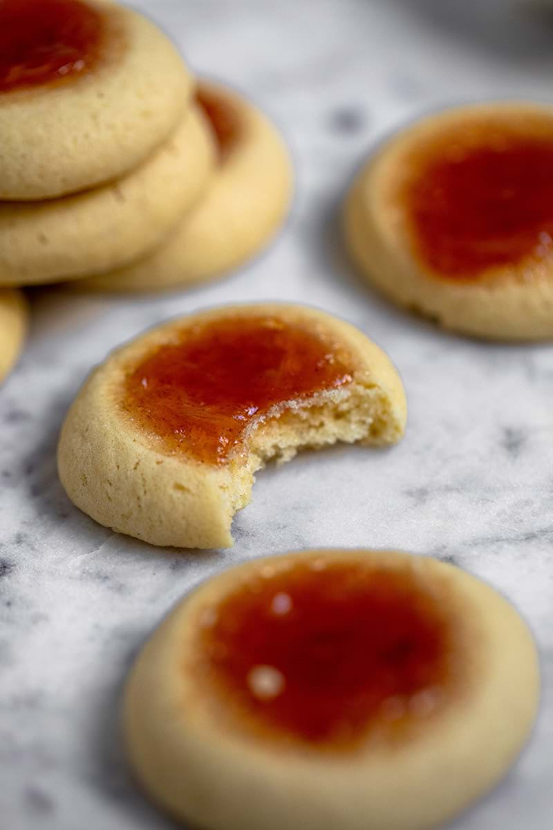 Closeup shot of a thumbprint cookie minus a bite