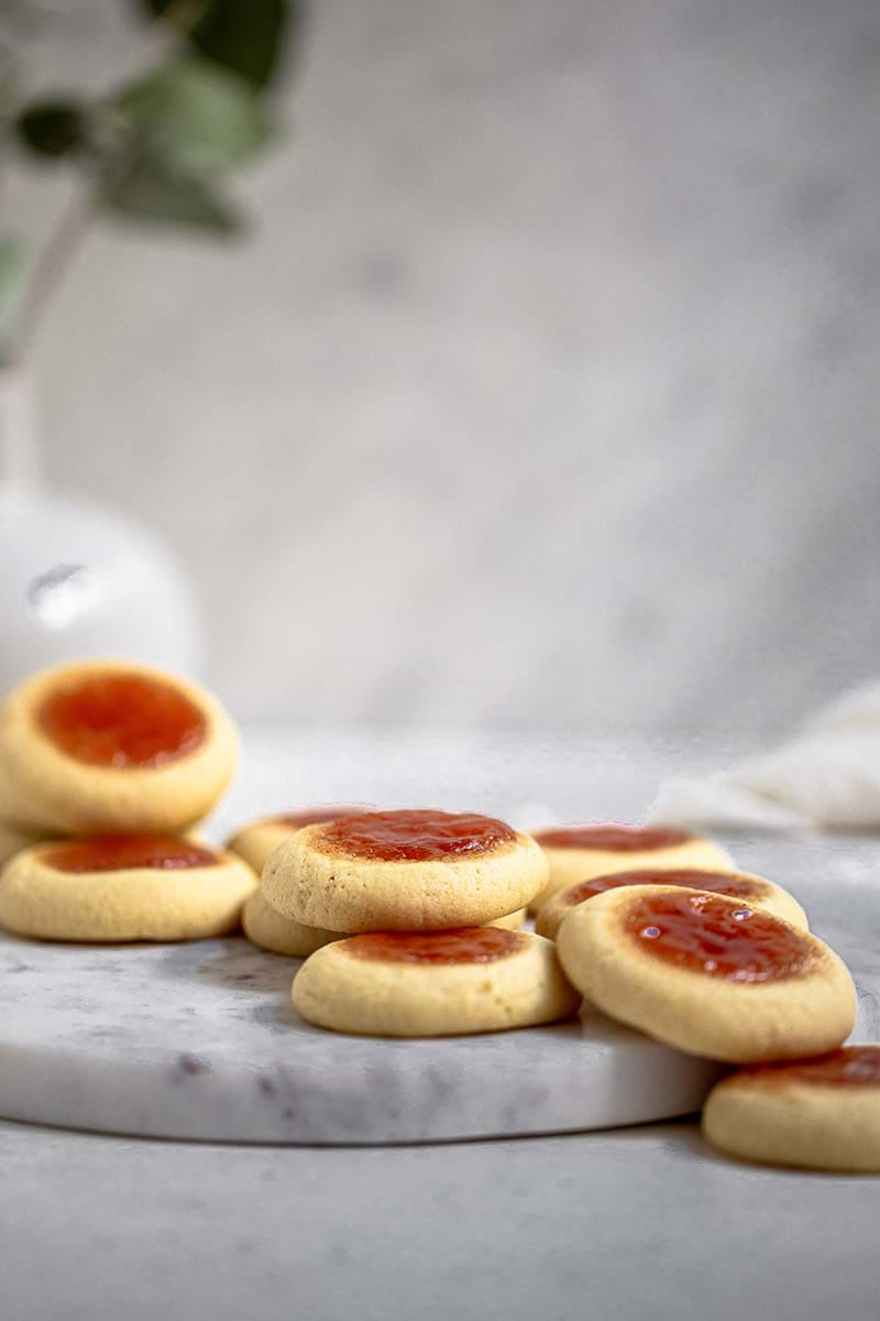 90° shot of the thumbprint cookies disposed in the shape of a cascade