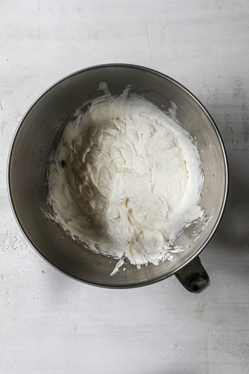 Whipped cream inside a mixing bowl.