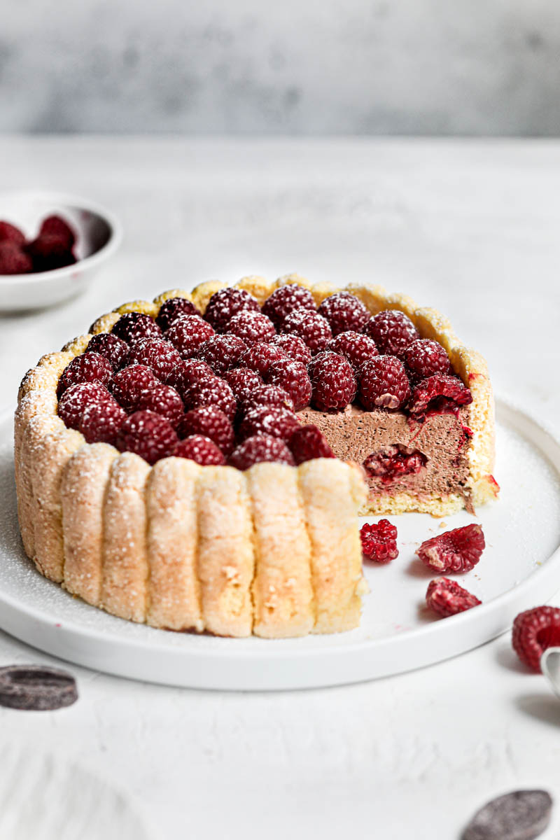 The sliced raspberry and chocolate charlotte cake showing off the silky chocolate interior.