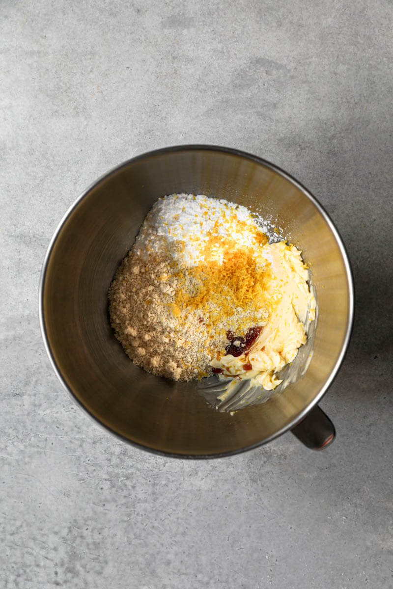 Bowl with softened butter, almond flour, lemon zest and powdered sugar