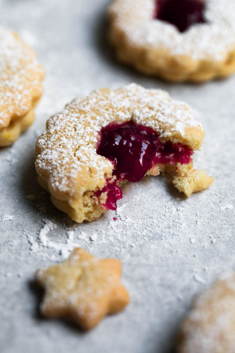 One raspberry linzer cookie with a bite off