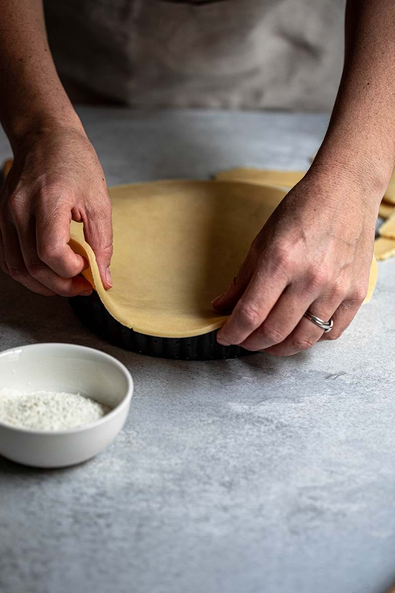 Action shot: lining the tart tin with the shortbread crust