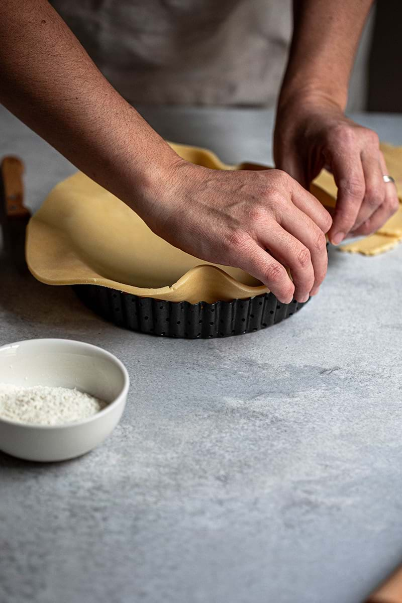 Action shot: lining the tart tin with the shortbread crust