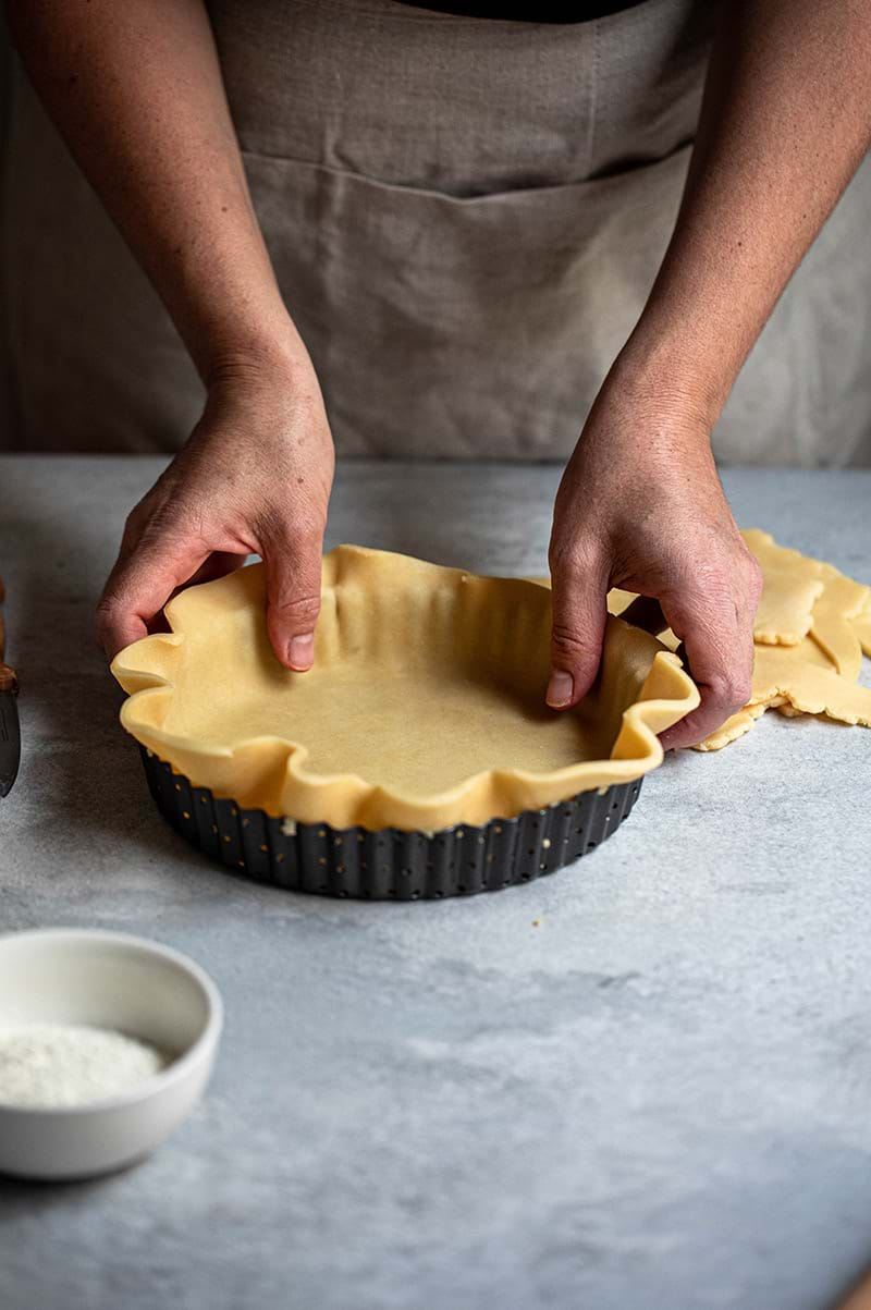 Action shot: lining the tart tin with the shortbread crust